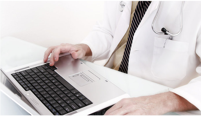 Medical billing consultant reviewing healthcare data on a laptop